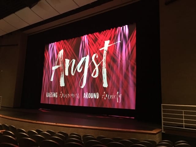 "Angst" on screen on stage